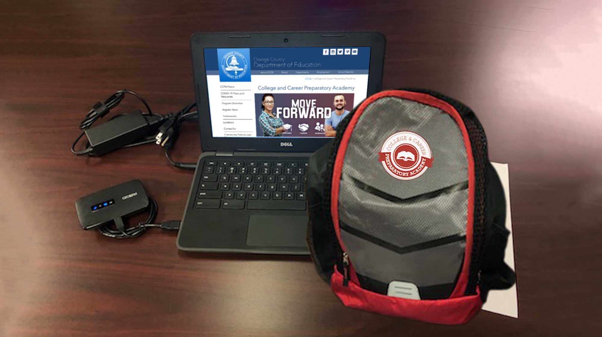 Laptop open to OCDE website and a CCPA backpack on a desk